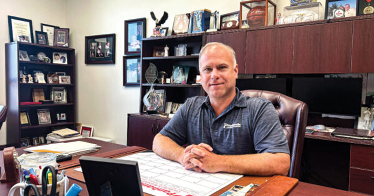 Bob Contraguerro Jr. at a desk