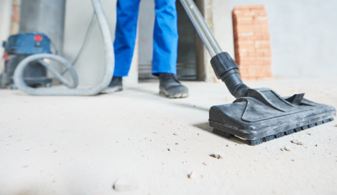 Person cleaning property with equipment