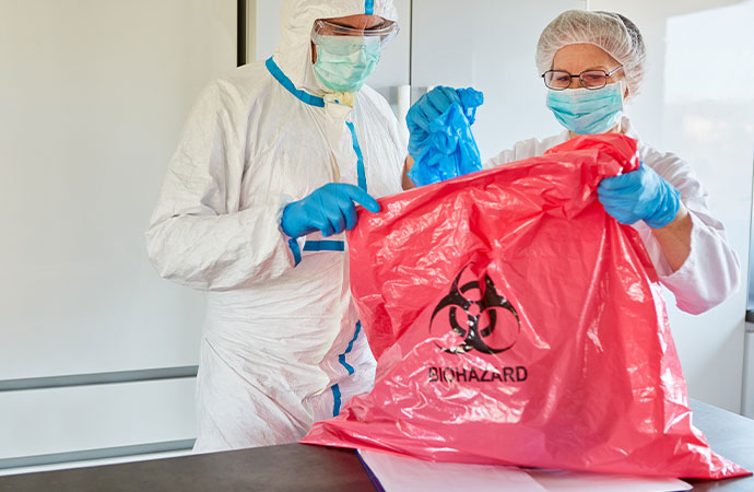 Disposing hazardous material inside biohazard bag