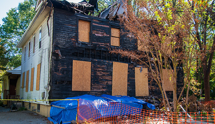 Boarded-up windows of a fire damaged residential house