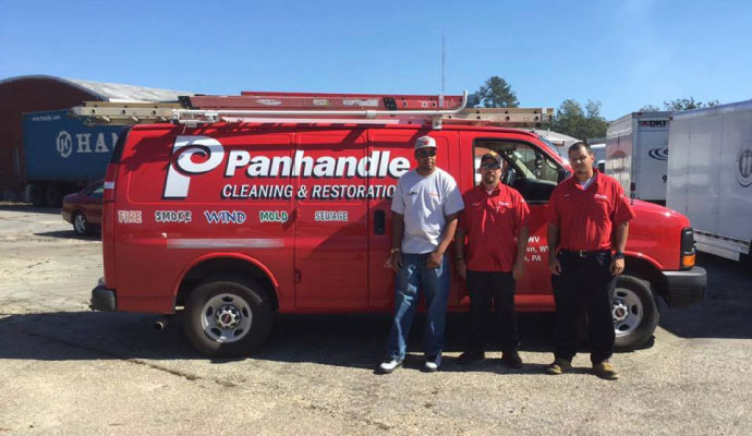 Crew members with Panhandle Cleaning and Restoration service vehicle