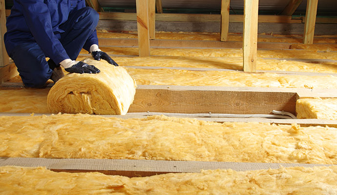 Expert installing insulation in an attic