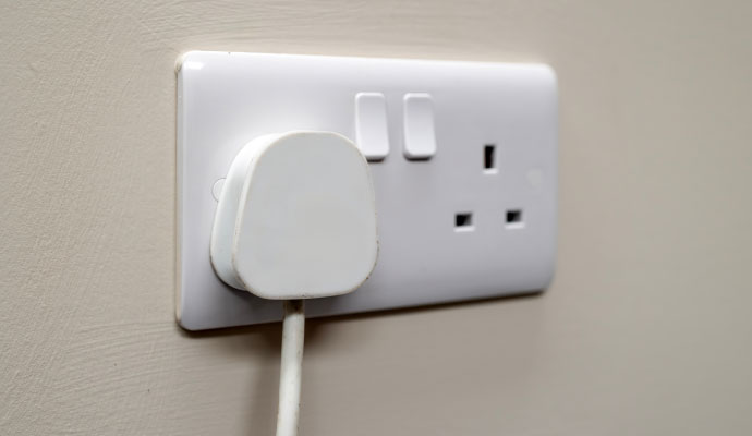 Electrical wall outlet with plug