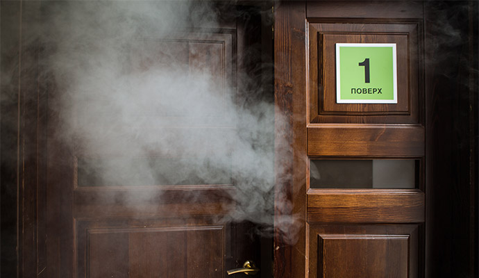 Thick white smoke is spreading inside the room