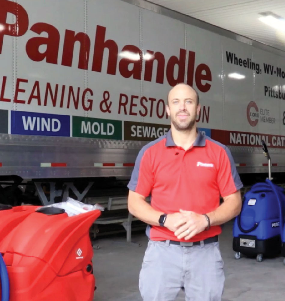 Josh standing in front of Panhandle Cleaning & Restoration service vehicle