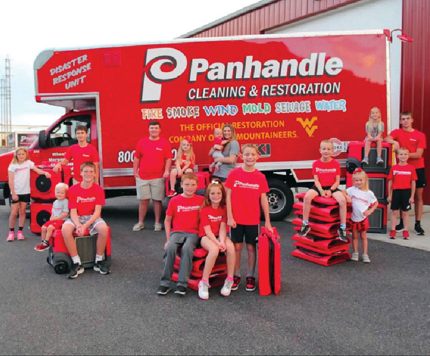 Panhandle families in front of their service vehicle
