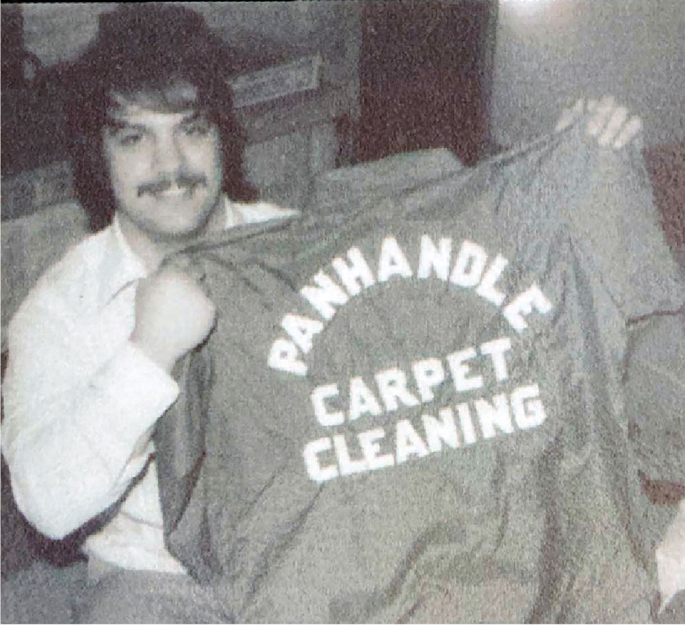 Person holding a Panhandle Cleaning & Restoration t-shirt when they established the company