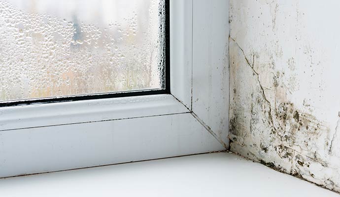 Heavy water condensation on a glass window pane