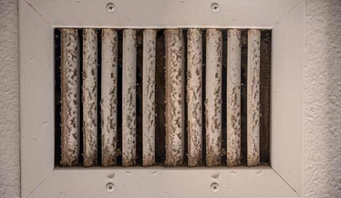 HVAC air vent heavily covered in dust