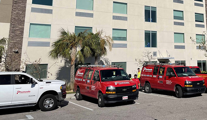  Panhandle Cleaning & Restoration service vans parked outside commercial building