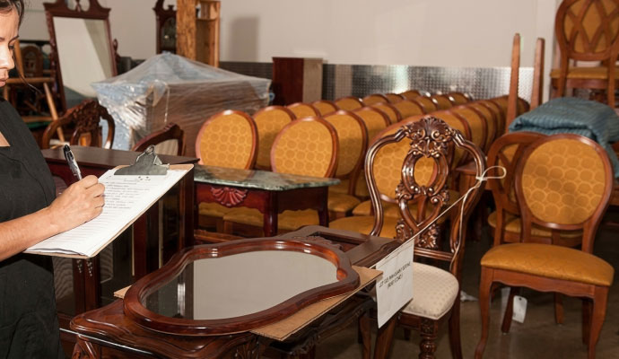 Person taking inventory of furniture