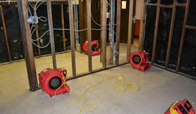 Professional water damage restoration service with equipment