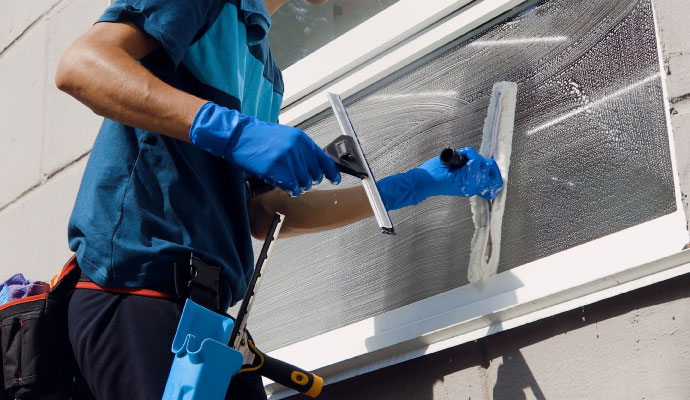 Professional window cleaning service in progress