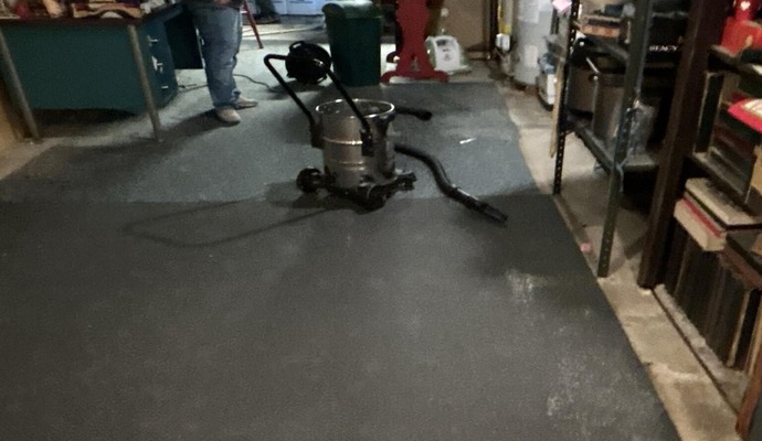 A Professional restoring water damaged floor with equipment