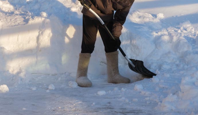 Person cleaning snow with equipment