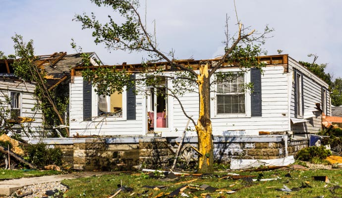 Residential house with destroyed roof and structural damage after a hurricane