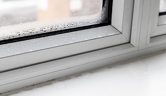 Condensation and water leaks around a window frame.