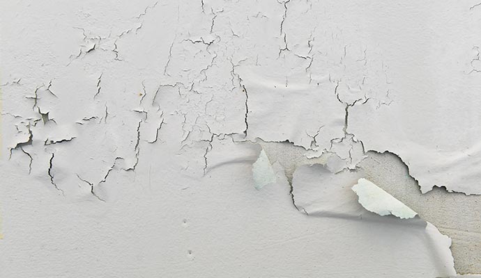 Wall paint peeling and cracking due to water damage