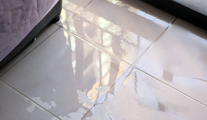Water pooling on ceramic tiled floor