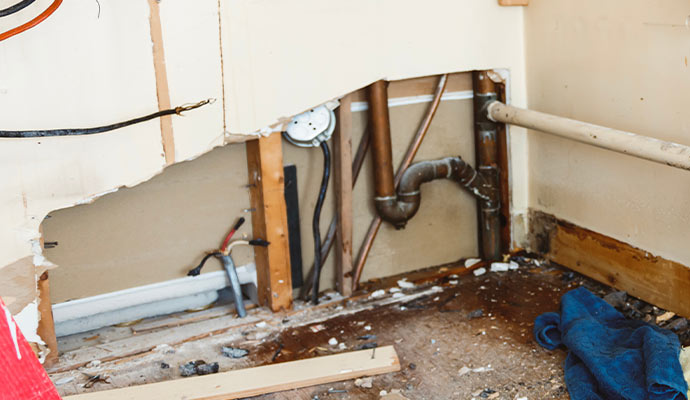 Exposed plumbing water damage wall repair