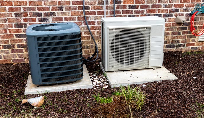 Outdoor HVAC unit on concrete pads.