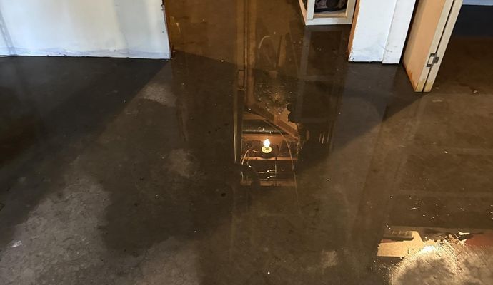A concrete floor covered in standing water