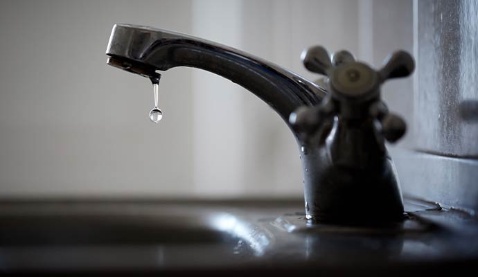 Water dripping from a leaky faucet Water dripping from a leaky faucet