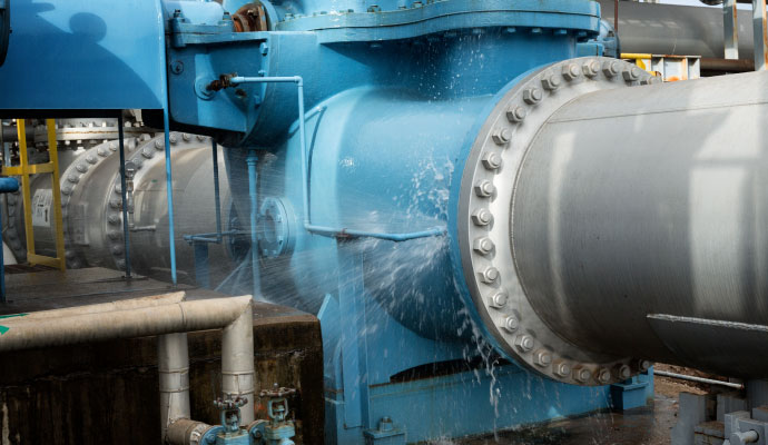 Water leak spraying from a large industrial pump