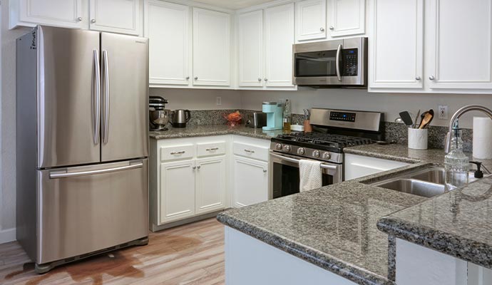 Water leaking onto kitchen floor from refrigerator